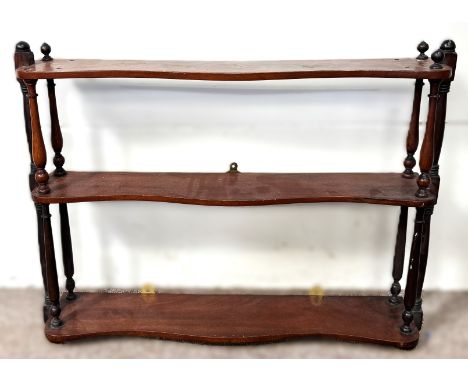 A three tier hanging wall shelf with turned supports, 57 x 75 c 15 cm.