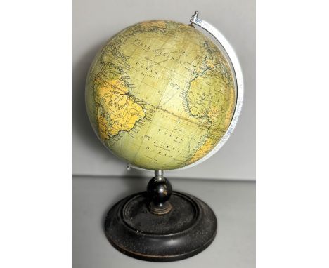 A c. 1920 Philip's 9 inch Terrestrial Globe on dished ebonised base, 38 cm.
