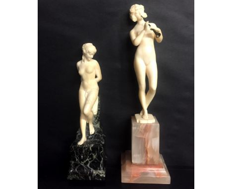 Two Art Deco ivory figures of nude female subjects: one modelled leaning against its original serpentine base, the base with 