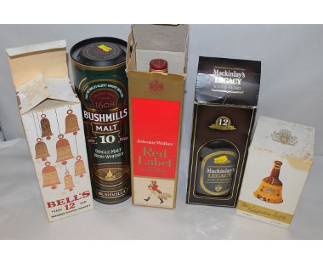 Five bottles of Whisky: Bushmills Malt 10 Year Old; Johnnie Walker Red Label; Mackinlay's 12 Year Old; and two Bells Scotch W