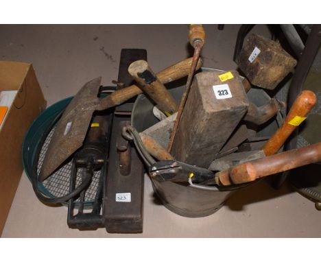 A collection of miscellaneous hand tools; an old metal bucket; a wooden plane; a foot pump; and a shovel; etc.