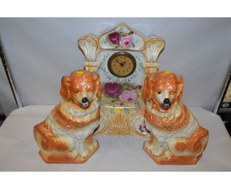 A pair of Wally dogs; and a Victorian mantel clock in ceramic case with hand painted floral decoration on blush ground.