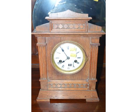 An early 20th Century eight-day mantel clock, enamel roman dial in oak case.