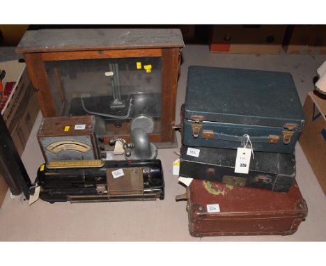 Vintage portable wireless in folding case; portable typewriter; chemical balance in glazed case; Elliot voltmeter; a Klaxon; 