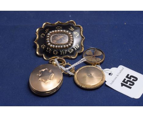 A mourning brooch, the centre of the plaque set with plaited hair, surrounded by half pearls and black enamel, inscribed 'In 