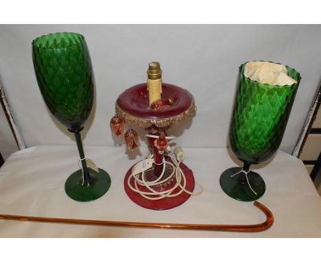 An oversized green glass goblet and wineglass; and a red glass candlestick, converted to electricity; together with an amber 