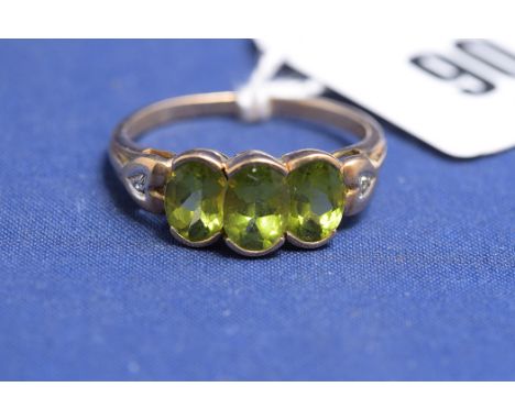 A peridot and diamond ring, on 9ct yellow gold shank, ring size R, 2.7grms gross.