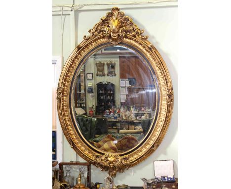 Large oval gilt framed bevelled wall mirror