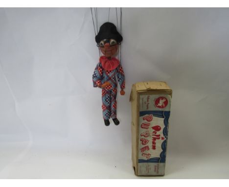 A Pelham Puppets type SM Harlequin puppet, round wooden head with painted features and moving mouth, in original brown card b