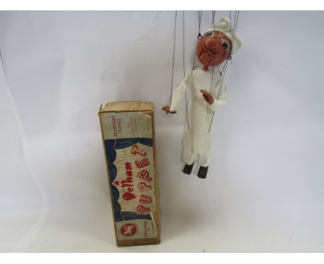 A Pelham Puppets type SM Chef puppet, round wooden head with painted features and moving mouth, in original brown card box