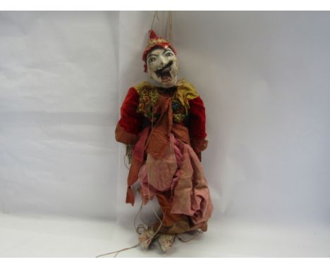 A painted wooden marionette puppet in traditional outfit, probably Thai