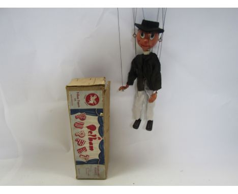 A Pelham Puppets type SM Parson puppet, wooden head with painted features, felt hair and moving mouth, in original brown card