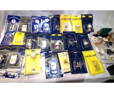 Selection of dolls house electric lighting, fires, etc includes ceiling, table lights, spare bulbs etc, some in packets. P&am