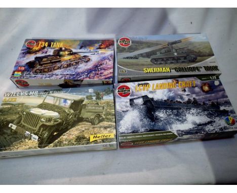 Four 1/72 scale military vehicle kits to include Airfix landing craft, Sherman Calliope, Airfix T34 tank and Heller Jeep, all