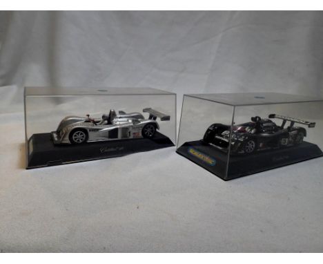 Two Scalextric Cadillac L.M.P cars to include a silver M1 and a black M3 in plastic boxes, both in very good to excellent con