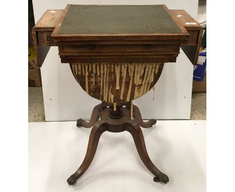 A 19th Century rosewood and cross-banded games / work table with reading slope top enclosing a backgammon board flanked by tw