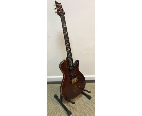 A Mikael Akerfeldt SE guitar for PRS Guitars with dark stained maple front and gilt decoration and bird mother of pearl inlai
