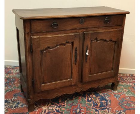 An 18th Century French oak buffet, the top with moulded edge above a single frieze drawer and two fielded panel cupboard door