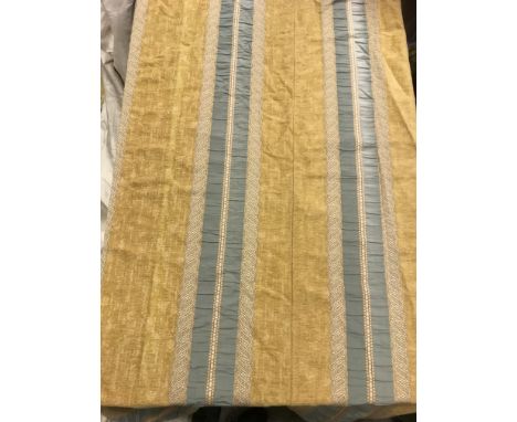 One pair of chenille type mustard ground lined curtains with braid and ribbon teal coloured decoration, with fixed triple pen
