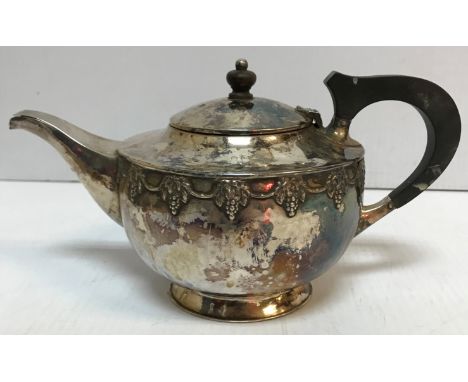 A George V silver teapot in the Arts and Crafts manner with grape and vine decoration (by Albert Edward Jones, Sheffield 1912