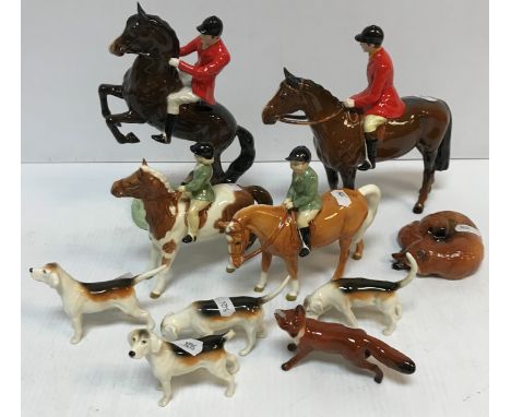 A collection of Beswick hunting figures to include "Huntsman on rearing horse", "Huntsman on standing horse" (chip to cap rim