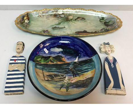 A Songlain Pottery plate decorated with coastal scene with figure and fishing boat and nets in foreground, signed B Povsky to