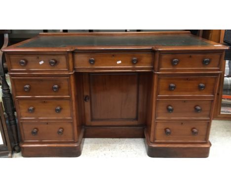 A Victorian break front kneehole desk, the top with shallow raised back and tooled and gilded leather insert top within a mou