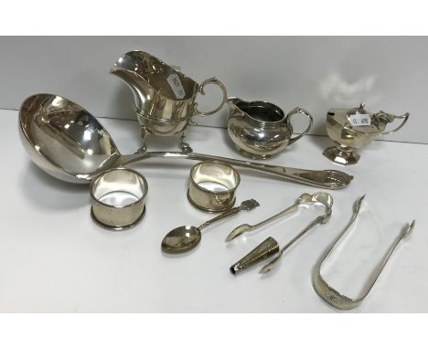A collection of silver wares to include two early 20th Century silver milk / cream jugs, one raised on three hoof feet with s