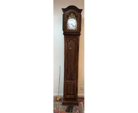 A late 18th / early 19th Century French Midi-Pyrenées walnut cased long case clock, the brass arched dial with sun and figura