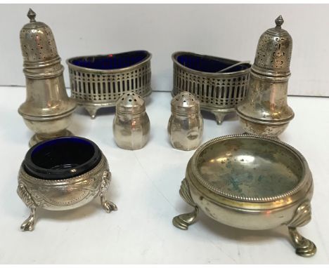 Two pierced silver oval salts with blue glass liners, two silver peppers of lantern form, two further silver peppers, a Victo