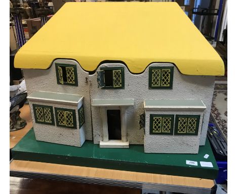 An early to mid 20th Century Triang painted wooden dolls house model 3146 "Y Bwtchyn Bach" a model of the Welsh style playhou