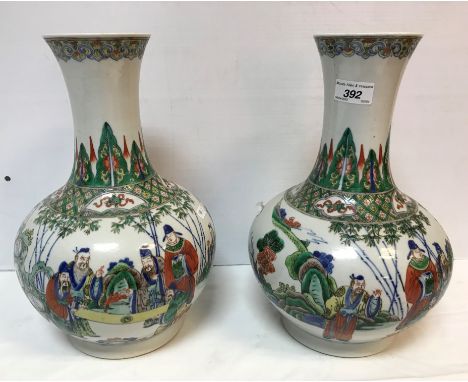 A pair of late 18th / early 19th Century Chinese Kangxi palette vases, near-matching with figural decoration depicting men vi