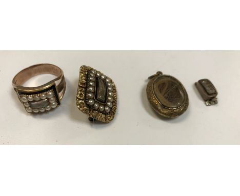 A Georgian seed pearl and gold mounted mourning ring with central hair plait and black enamel banding, inscribed verso "Eliz 