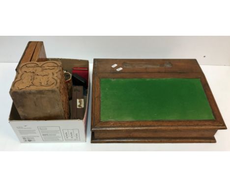 An oak desk top clerk's writing slope 35 cm deep x 43 cm wide x 10.5 cm high, a carved wooden tea caddy decorated with holly 