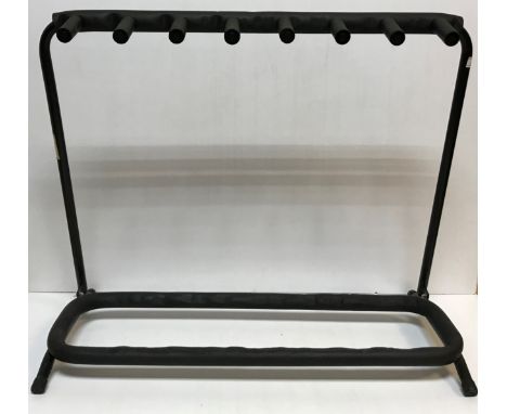 A free-standing seven section guitar stand, together with five further individual guitar stands and two adjustable air cushio