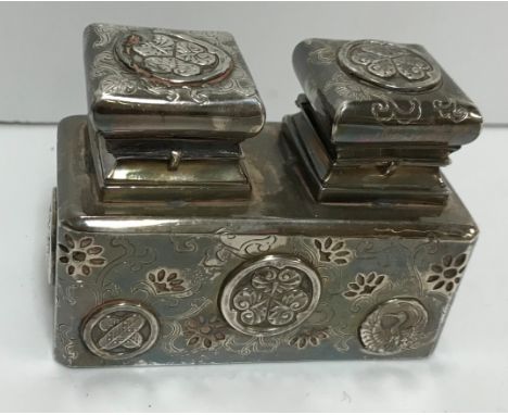 A Japanese silver mounted twin inkwell of rectangular section and with pierced and embossed foliate decoration, in the manner