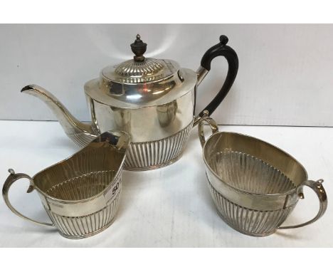 A late Victorian silver three piece tea set with half reeded decoration, the teapot with ebonised handle and finial (by Mappi