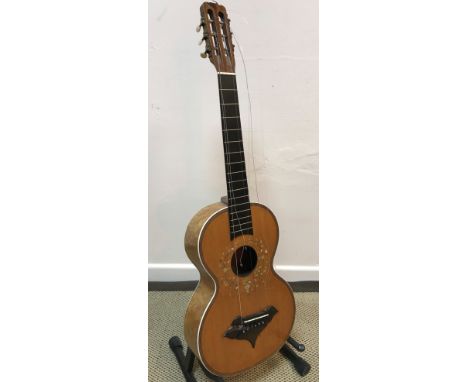 An early 20th Century acoustic guitar with mother of pearl inlaid floral decoration and birds eye maple back (un-named)