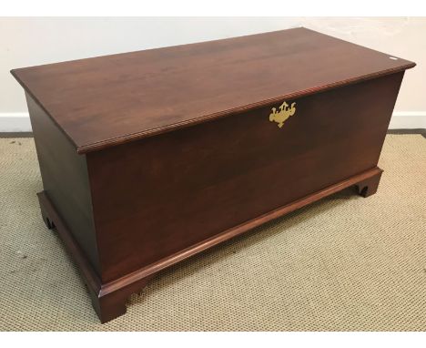 An American cherry wood coffer in the 18th Century style raised on bracket feet bearing brass plaque inscribed "Hand crafted 