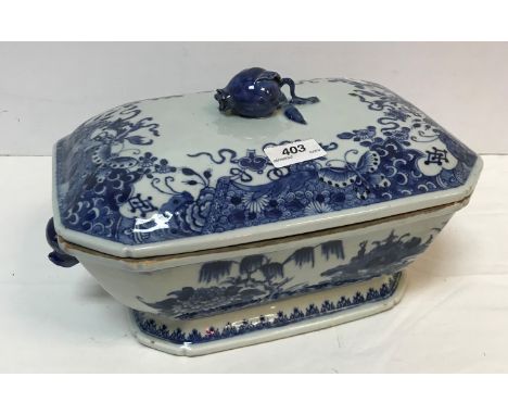 An 18th Century Chinese blue and white tureen and cover with pomegranate finial within a border of flowers and butterflies, t