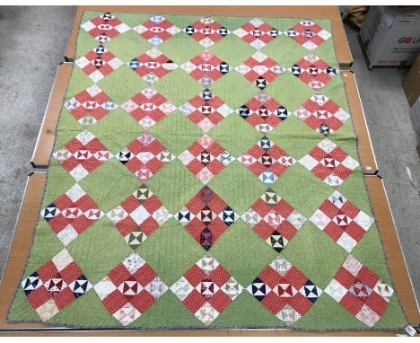 A mid 20th Century broken plate pattern type quilt with some earlier fabrics, 167 cm x 205 cm, together with an early 20th Ce