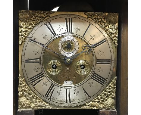 An 18th Century walnut cased long case clock, the eight day movement with square brass dial and pierced spandrals enclosing a