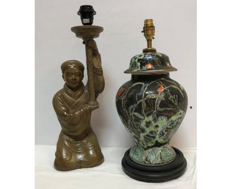 A 20th Century Chinese glazed terracotta figural table lamp as a woman kneeling holding aloft a torch 48.5 cm high including 