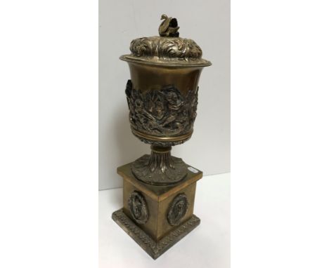 A late 19th Century plated lidded urn, the lid with swan finial and acanthus leaf decoration, the body of the urn set with ch