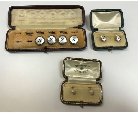 A pair of 15 carat blue enamel mother of pearl and ruby set shirt studs, 2.8 g, a pair of seed pearl and yellow metal mounted