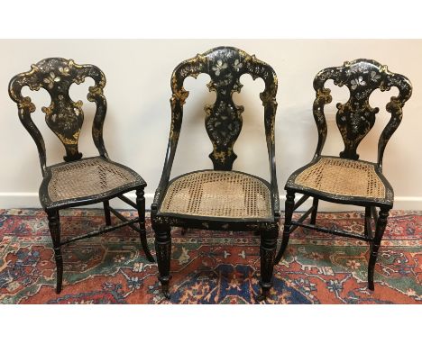 A pair of Victorian black lacquered mother of pearl inlaid and gilded salon chairs, the backs decorated with butterflies and 