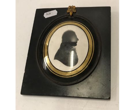 A 19th Century silhouette portrait bust study of a gentleman possibly a member of the Melville family with oval convex verre 