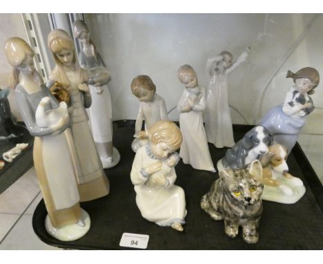 Nine assorted Lladro 'Nao' figurines, to include No. 4505 girl with lamb, girl with duck, girl holding puppy, pair of puppies