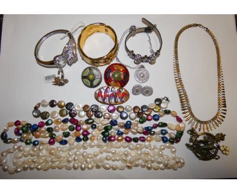 Three varicoloured cultured pearl necklaces, a paste set leopard bracelet and various costume jewellery.