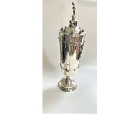 A George V sterling silver large trophy cup and cover, Omar Ramsden, with strap work decoration inset with polished stones su